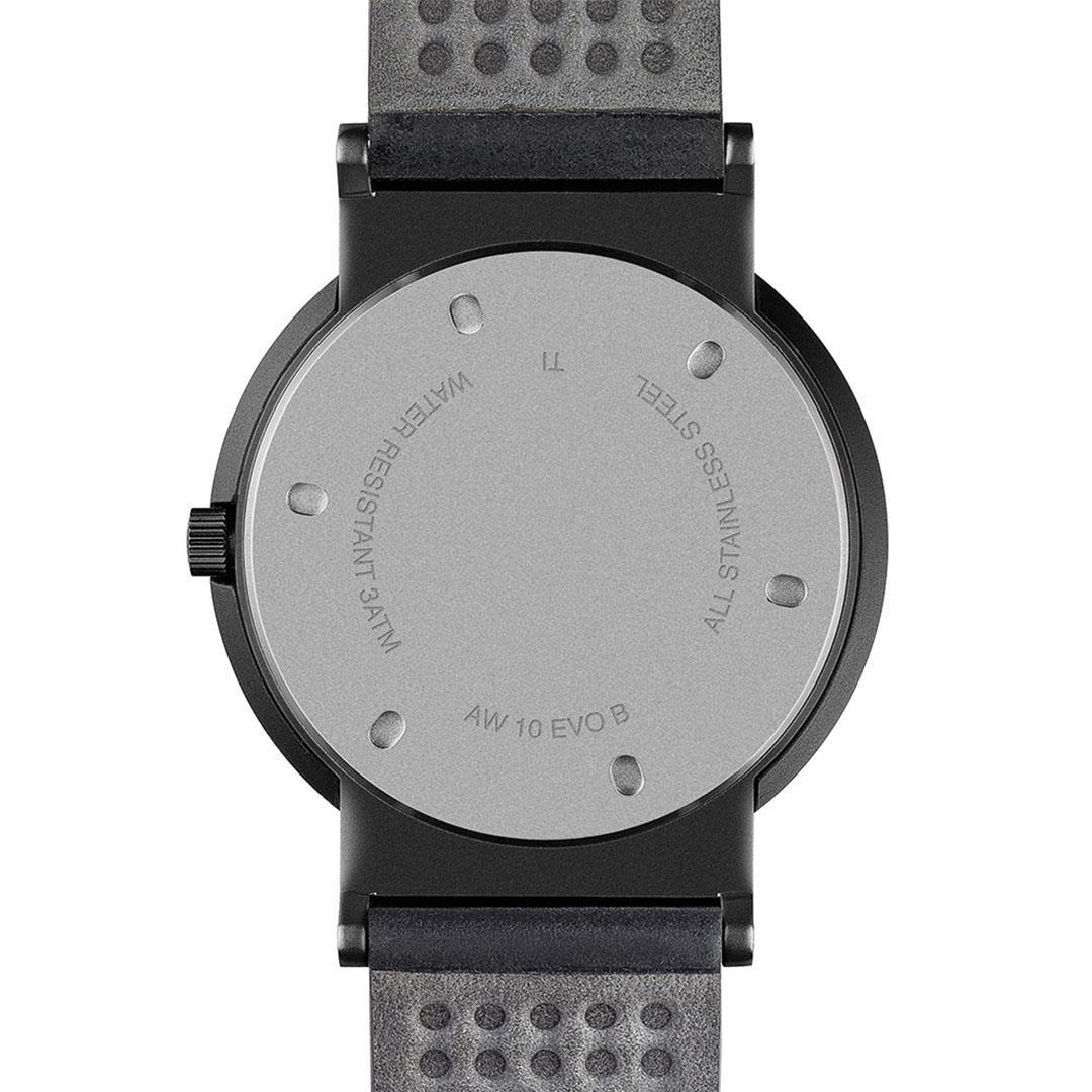 Back of black quartz watch case with engraved text and water-resistance rating