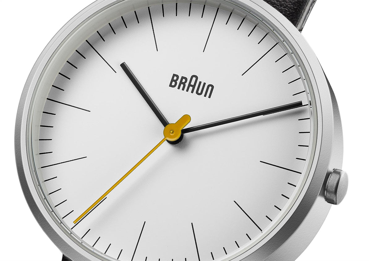Ladies quartz watch dial close-up, Braun logo, black hands and yellow tipped second hand