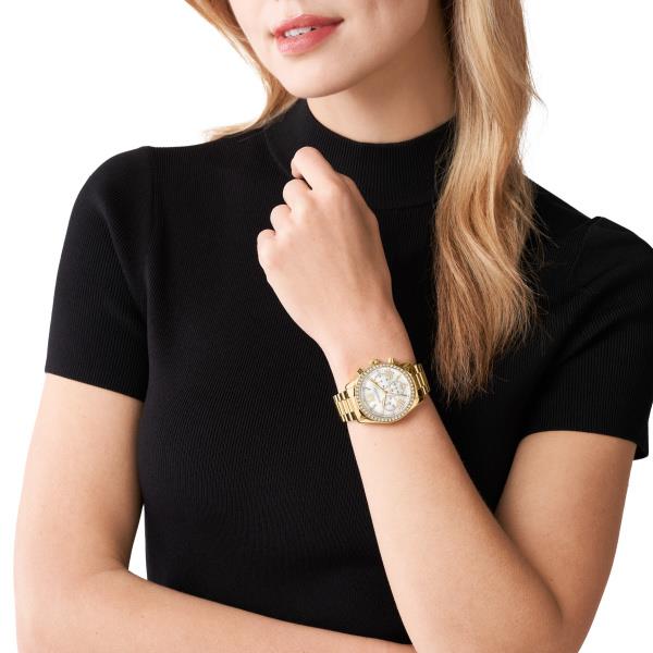 Worn on wrist: gold-tone women’s watch with white dial, Roman numerals, and rhinestone bezel