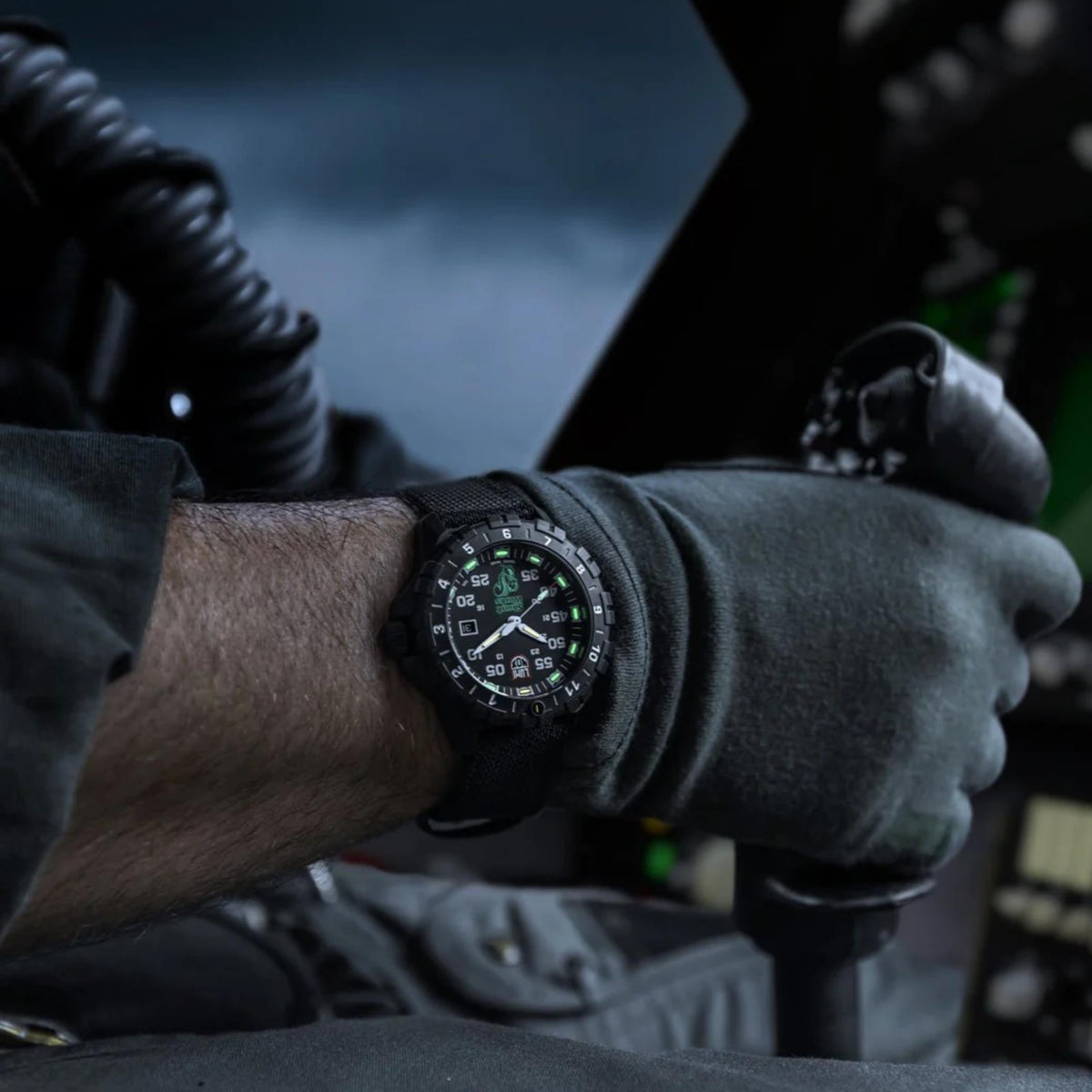 Men's black-dial quartz wristwatch with black textile strap on wrist