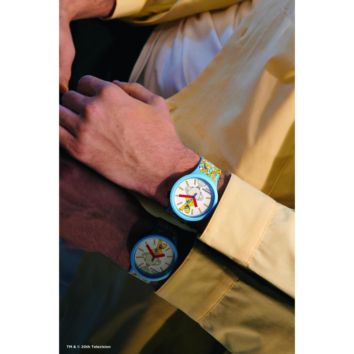 Light blue Swatch silicone watch on wrist, white dial with Dad graphic and colorful strap