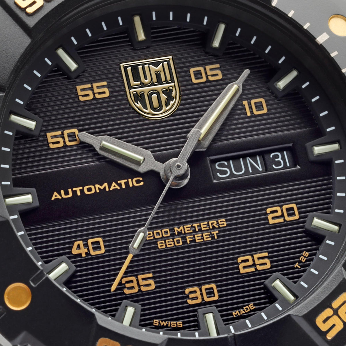 Close-up of black watch dial with LUMINOX NOX logo, gold hands, and date window