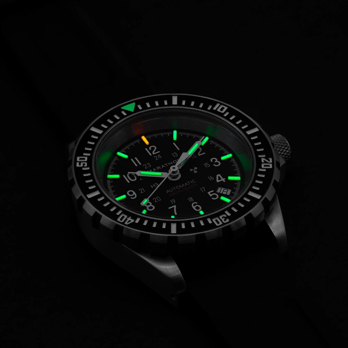 Men’s diver watch with black dial, green luminous hands, stainless steel bezel, black strap.
