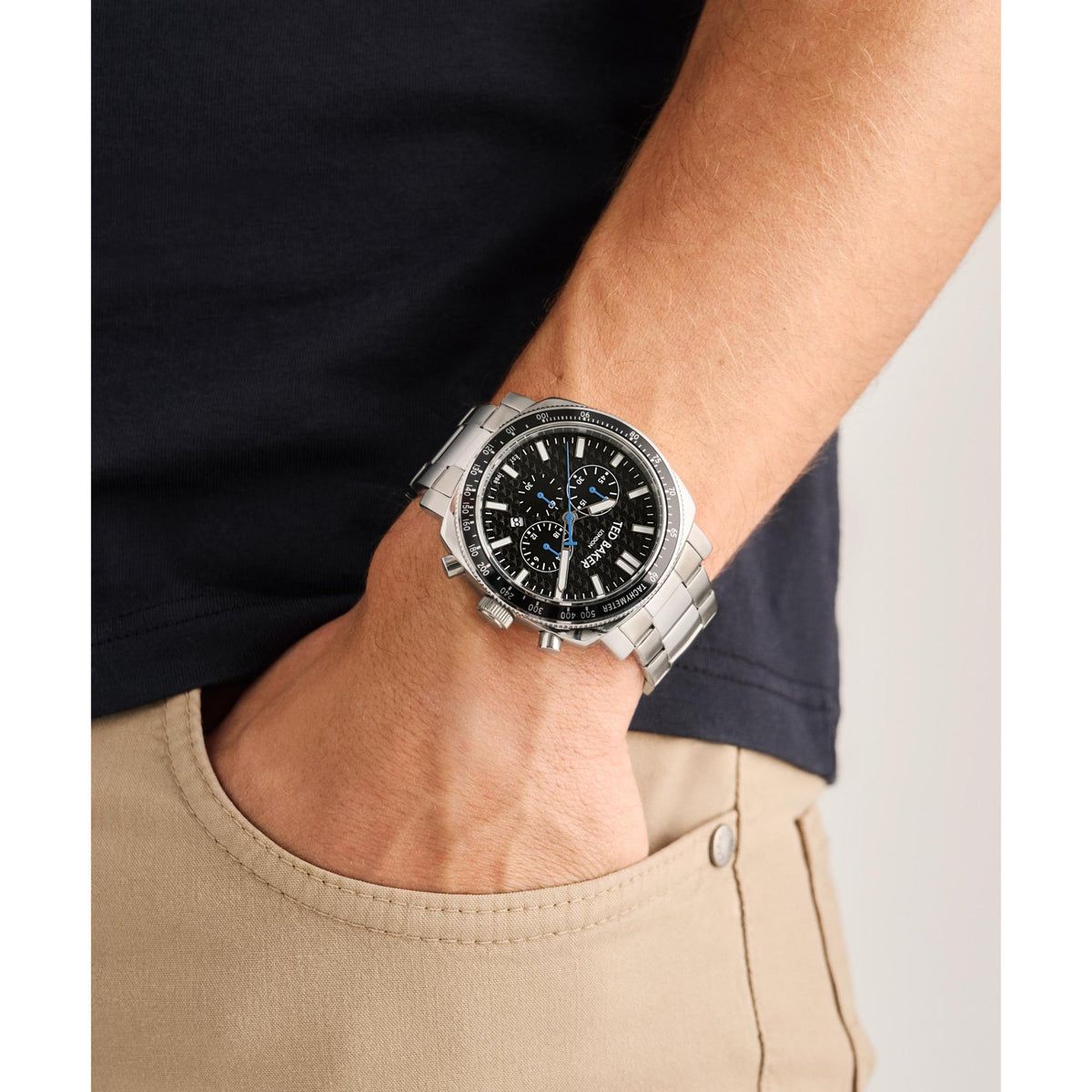 Men's stainless steel watch with black dial, chronograph subdials, on wrist