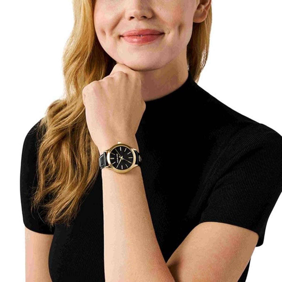 Michael Kors women’s watch worn on wrist with black dial and black leather strap