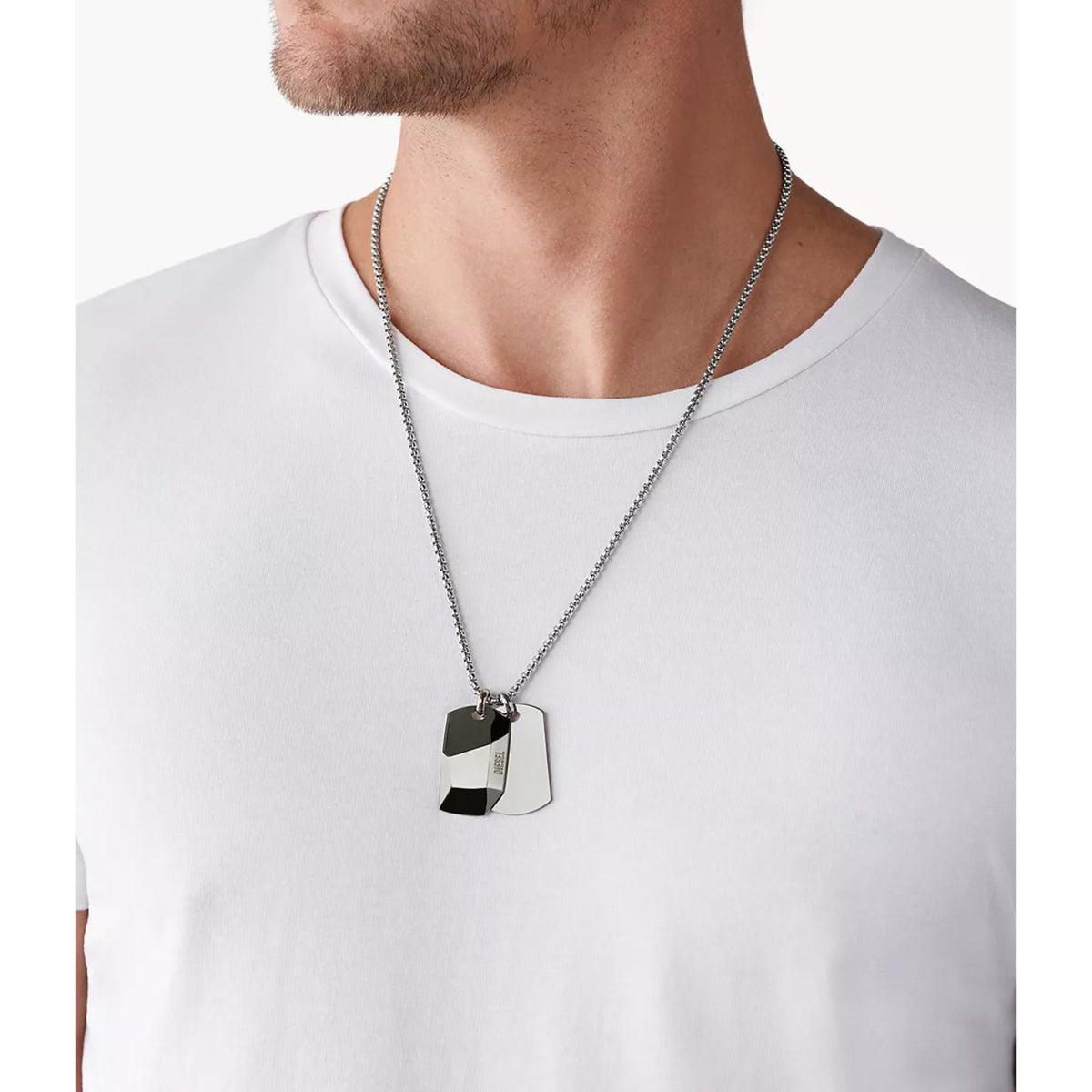 Stainless steel double dog tag necklace worn on chest with two engraved pendant tags