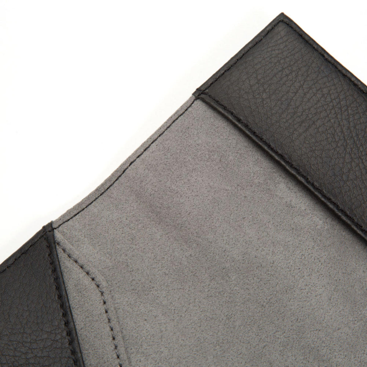 Close-up of open black passport holder showing gray lining and stitched seam
