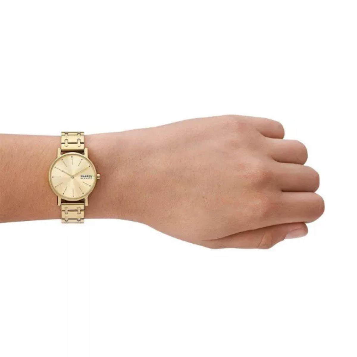 Gold stainless steel bracelet watch worn on wrist with cream dial