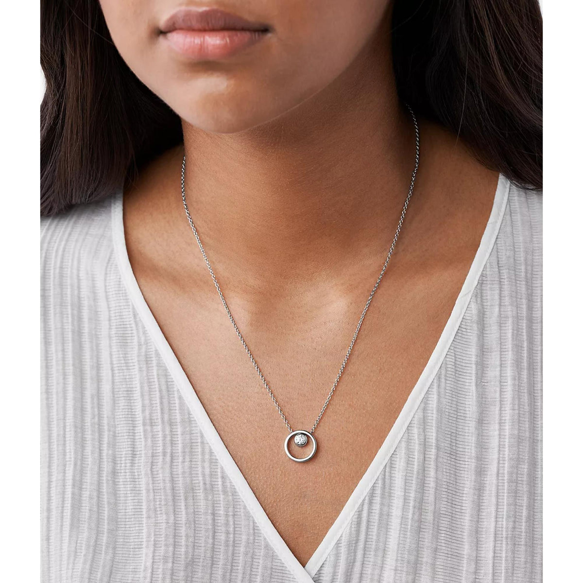 Silver-tone circle pendant necklace worn, round crystal in circular bezel