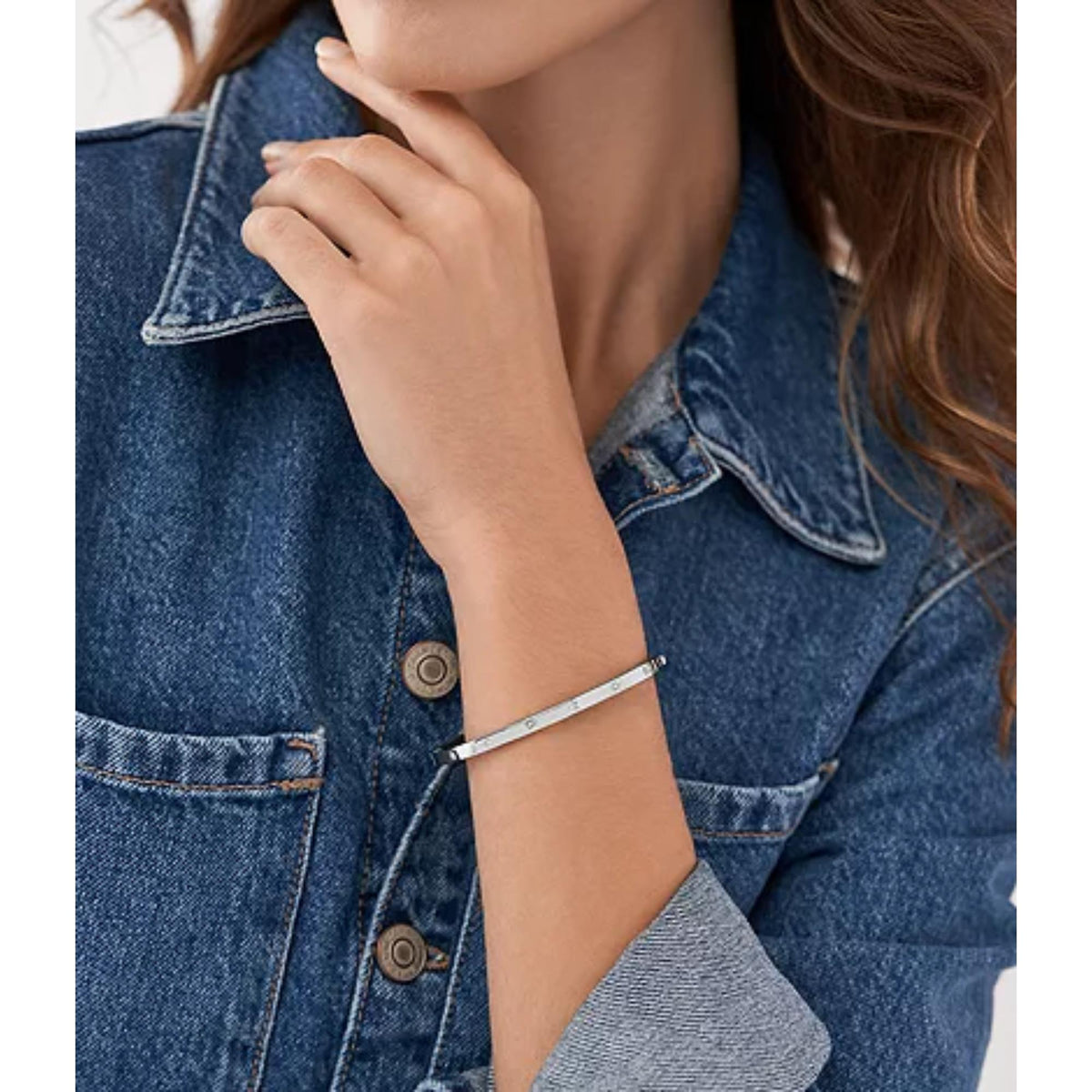 Stainless steel bangle bracelet with starburst accents worn on wrist
