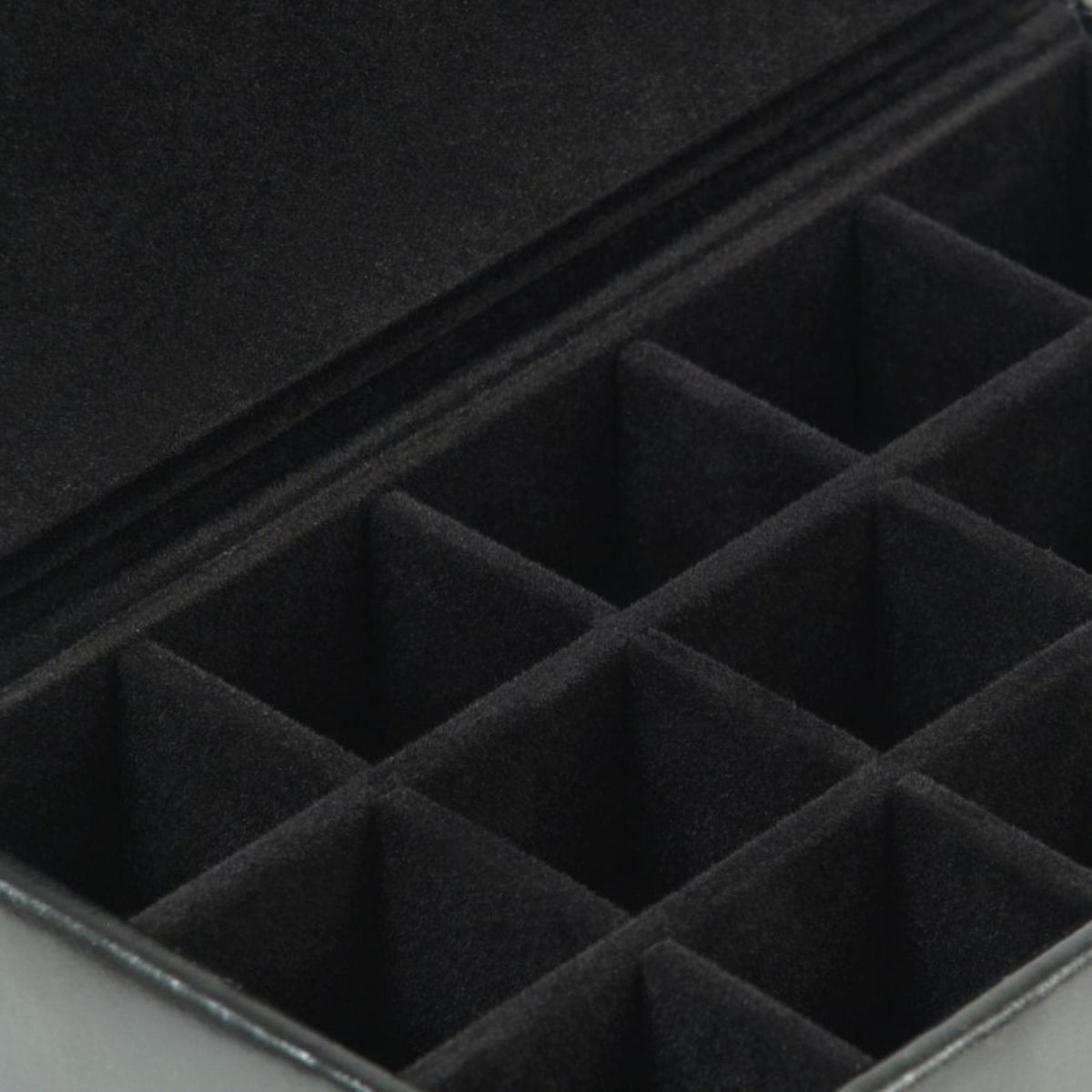 Cufflink box interior close-up with padded crosshatch compartments