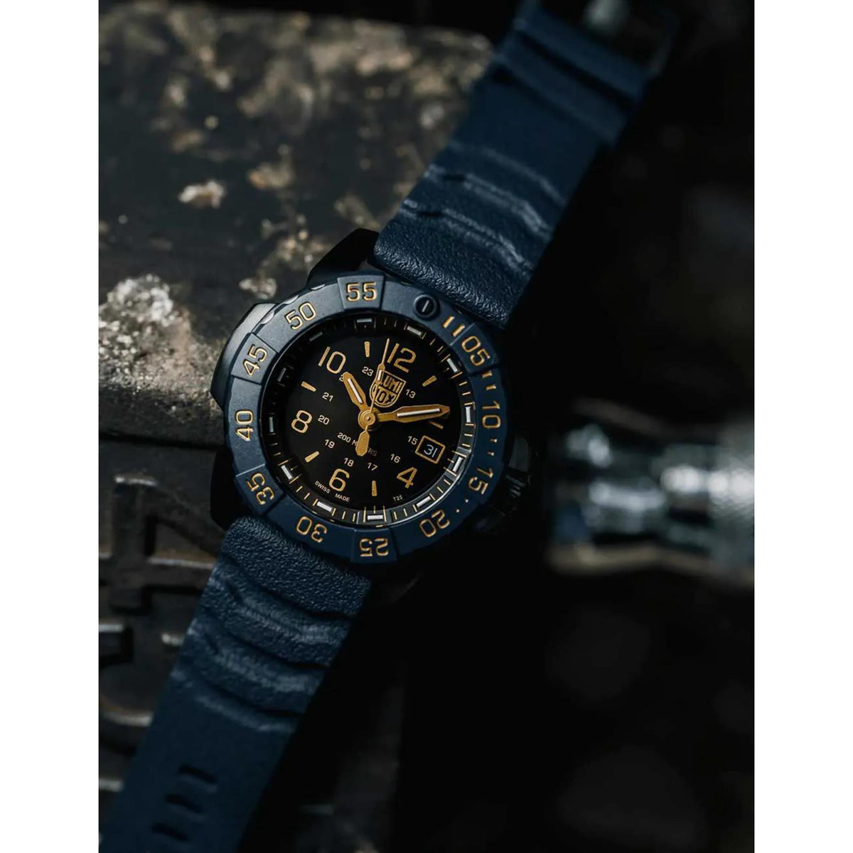 Men's diver watch on blue rubber strap, black dial with gold hands and date window