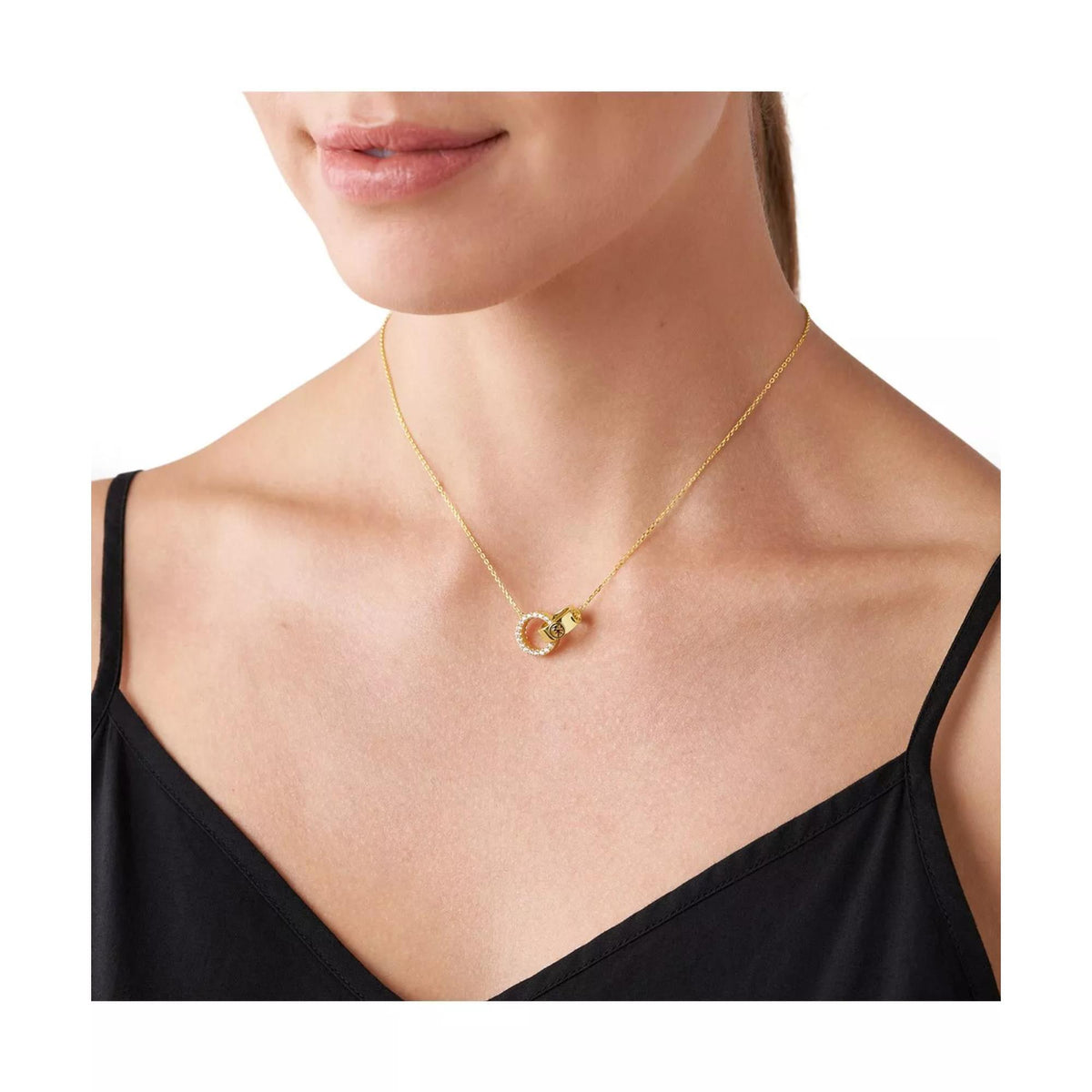 Gold-plated necklace on model with interlocking ring pendant and clear stones