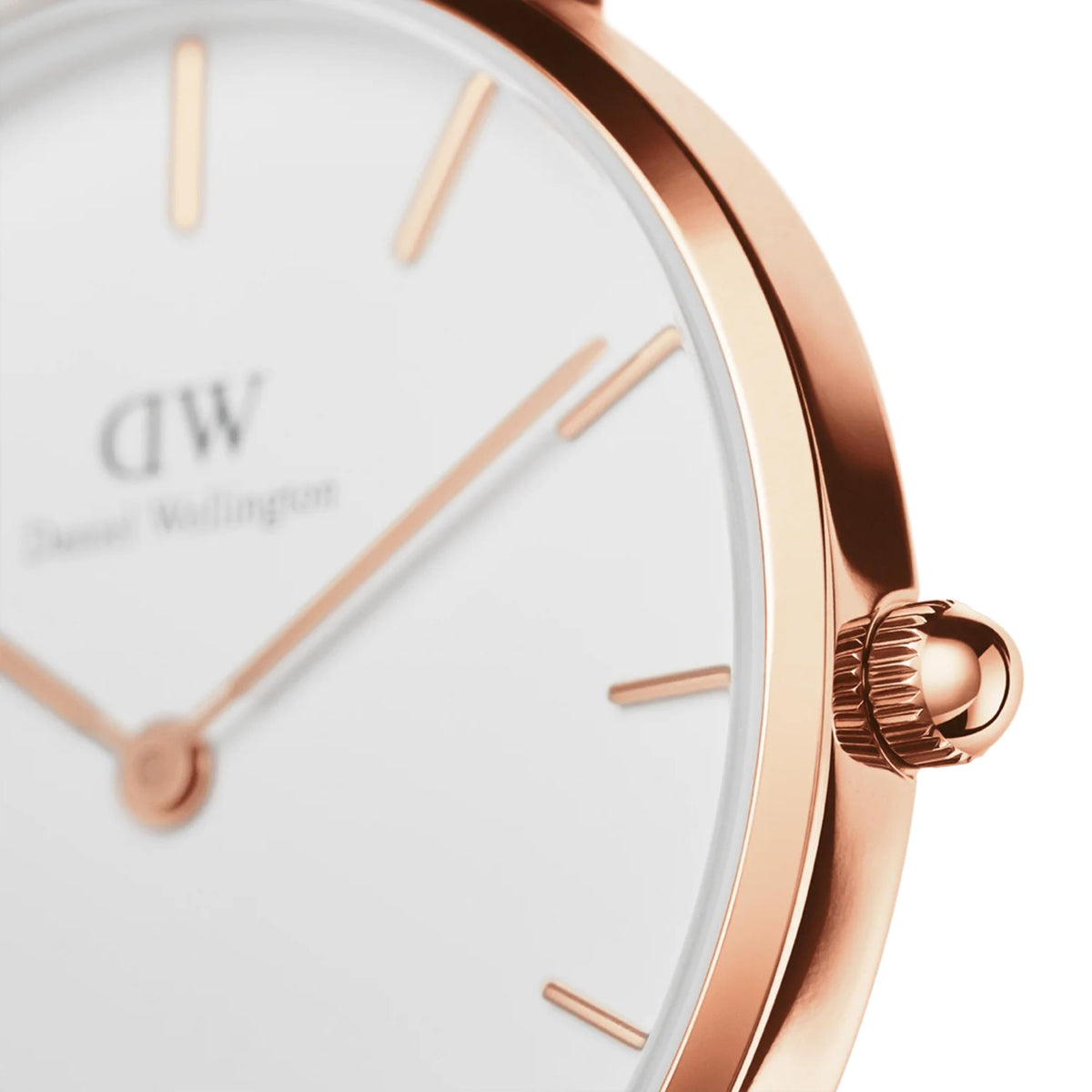 Close-up of rose-gold crown and bezel on white dial petite watch
