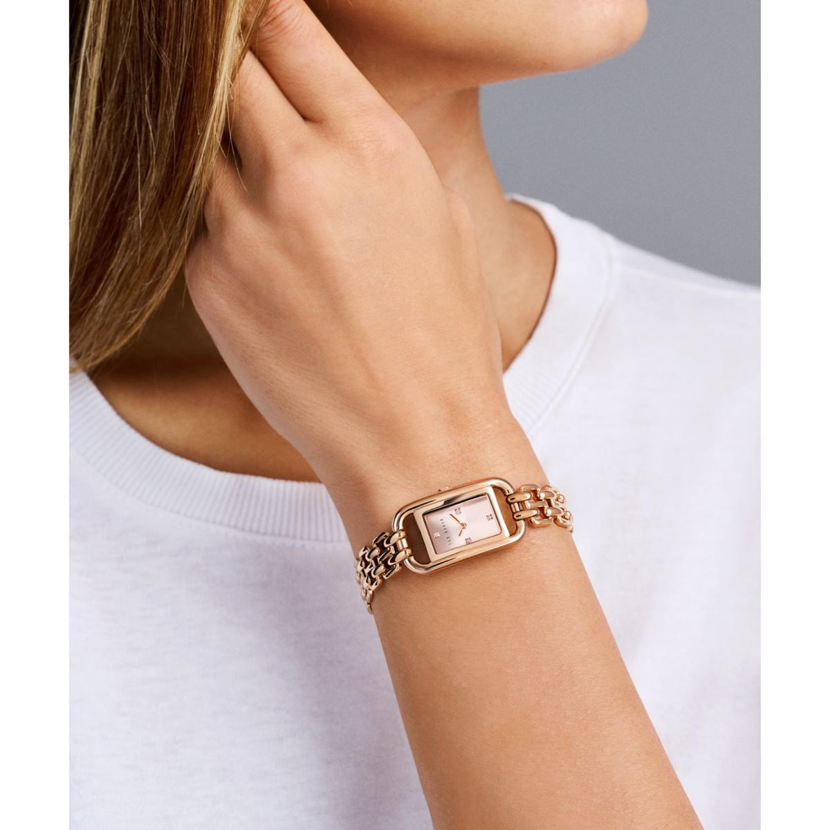 Rose gold tone ladies wristwatch with rectangular dial on chain-link bracelet