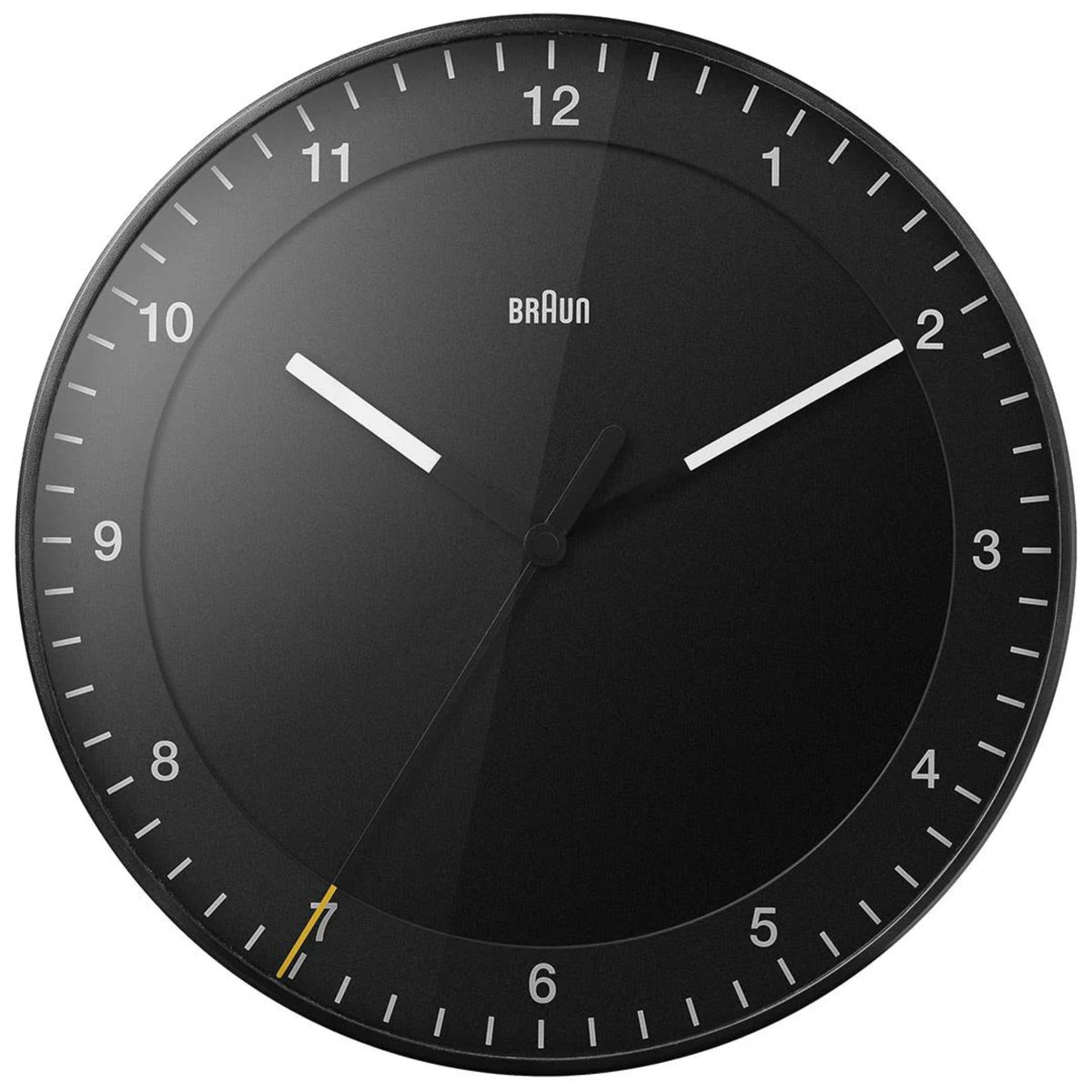 Braun wall clock close-up with black dial, white numerals, and silver hour and minute hands