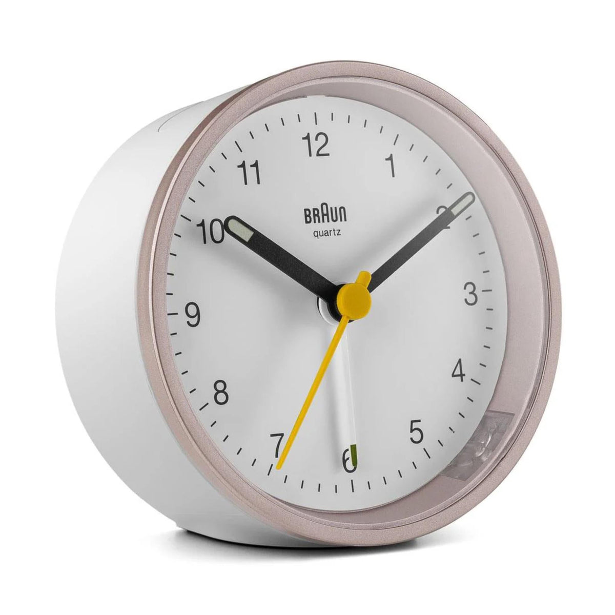 Braun quartz alarm clock front angle with white dial, rose-toned rim, and yellow second hand