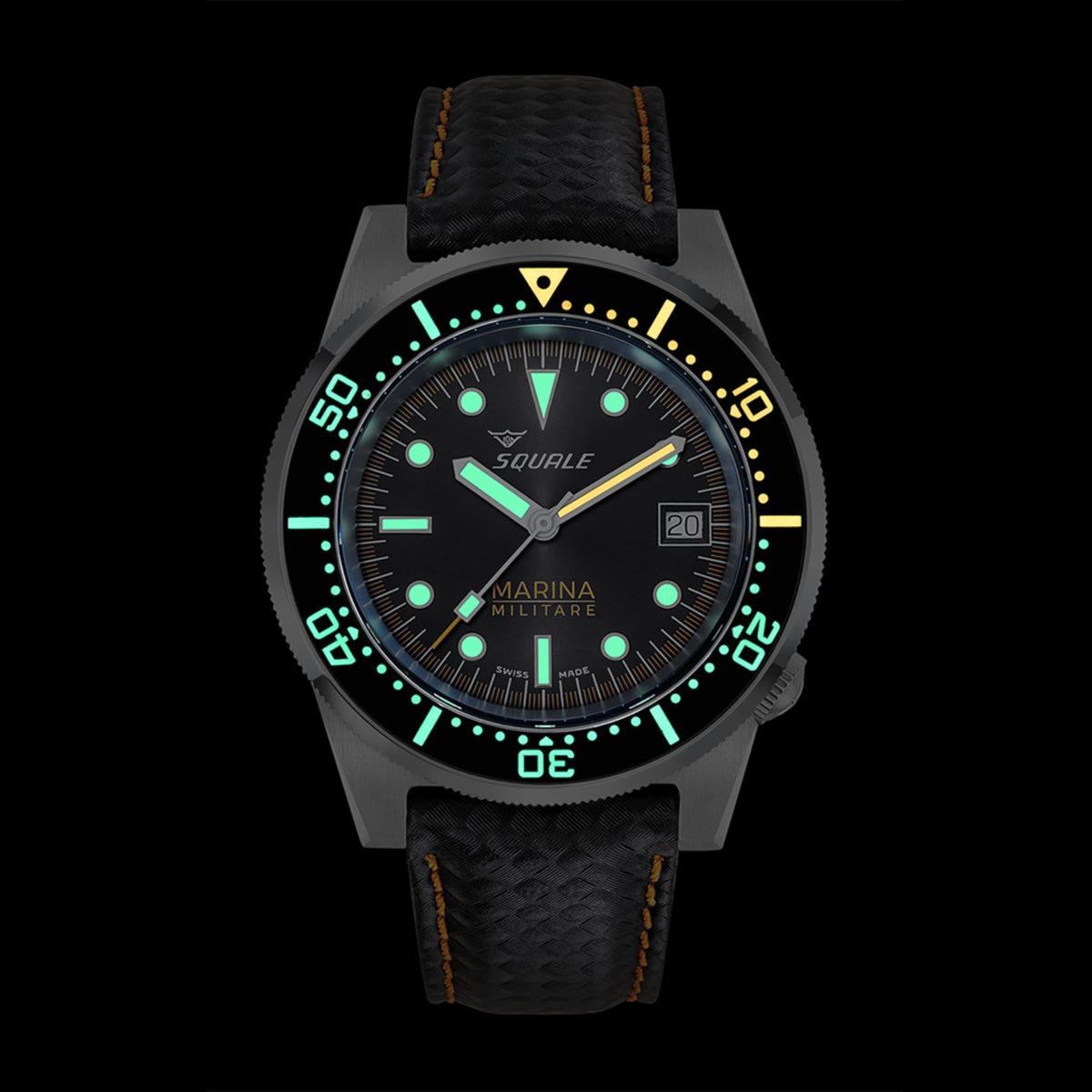 Men's diver watch front with green dial lume, black bezel markers, and black strap with orange stitching