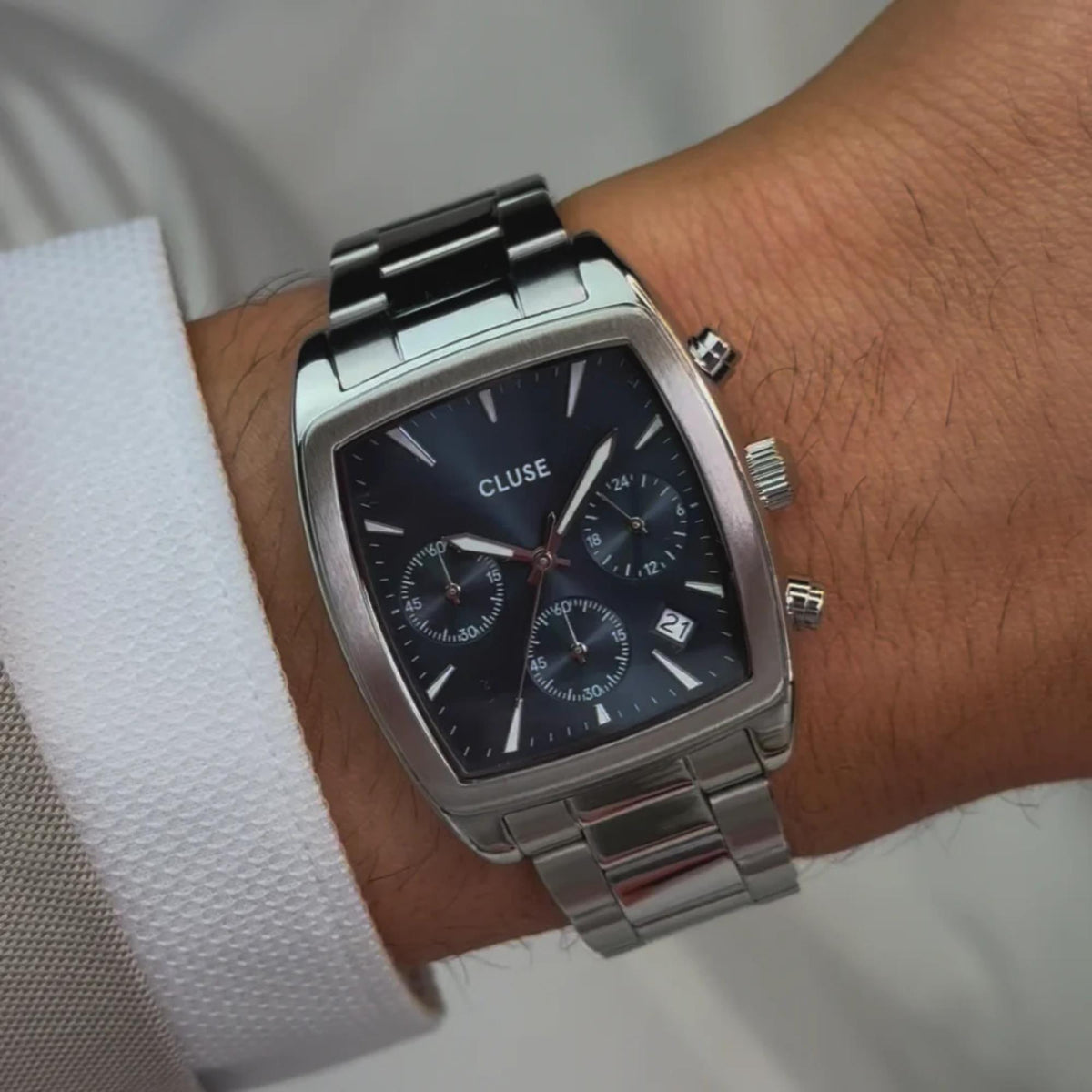 Men's steel chronograph watch with dark blue dial and metal bracelet on wrist