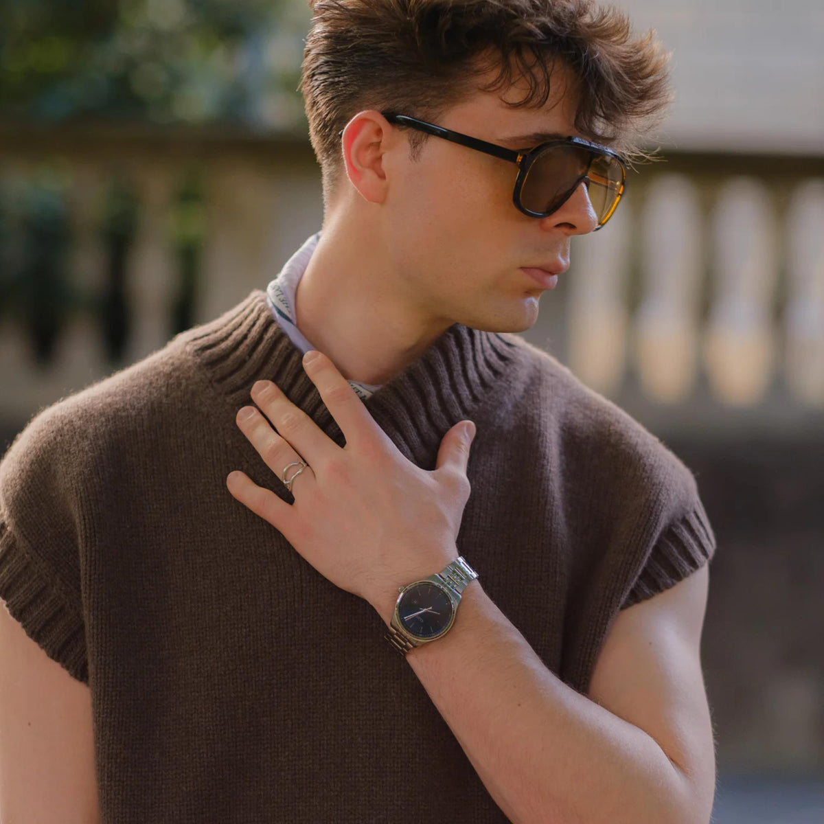 Men's steel wristwatch with dark blue dial and bracelet links on wrist