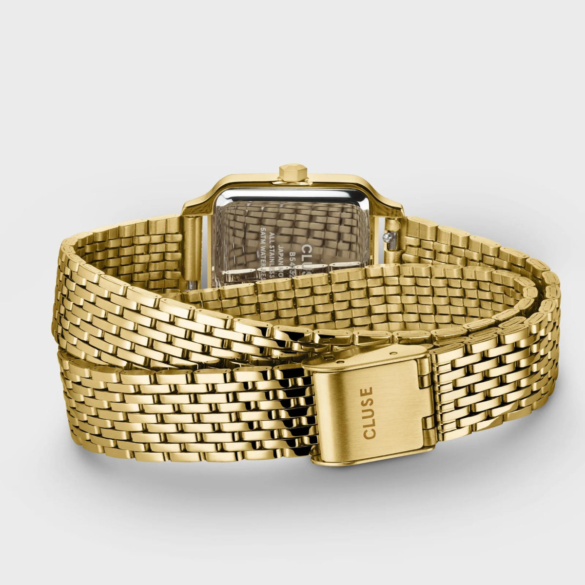 Gold-tone wristwatch with green dial and metal mesh bracelet, clasp visible