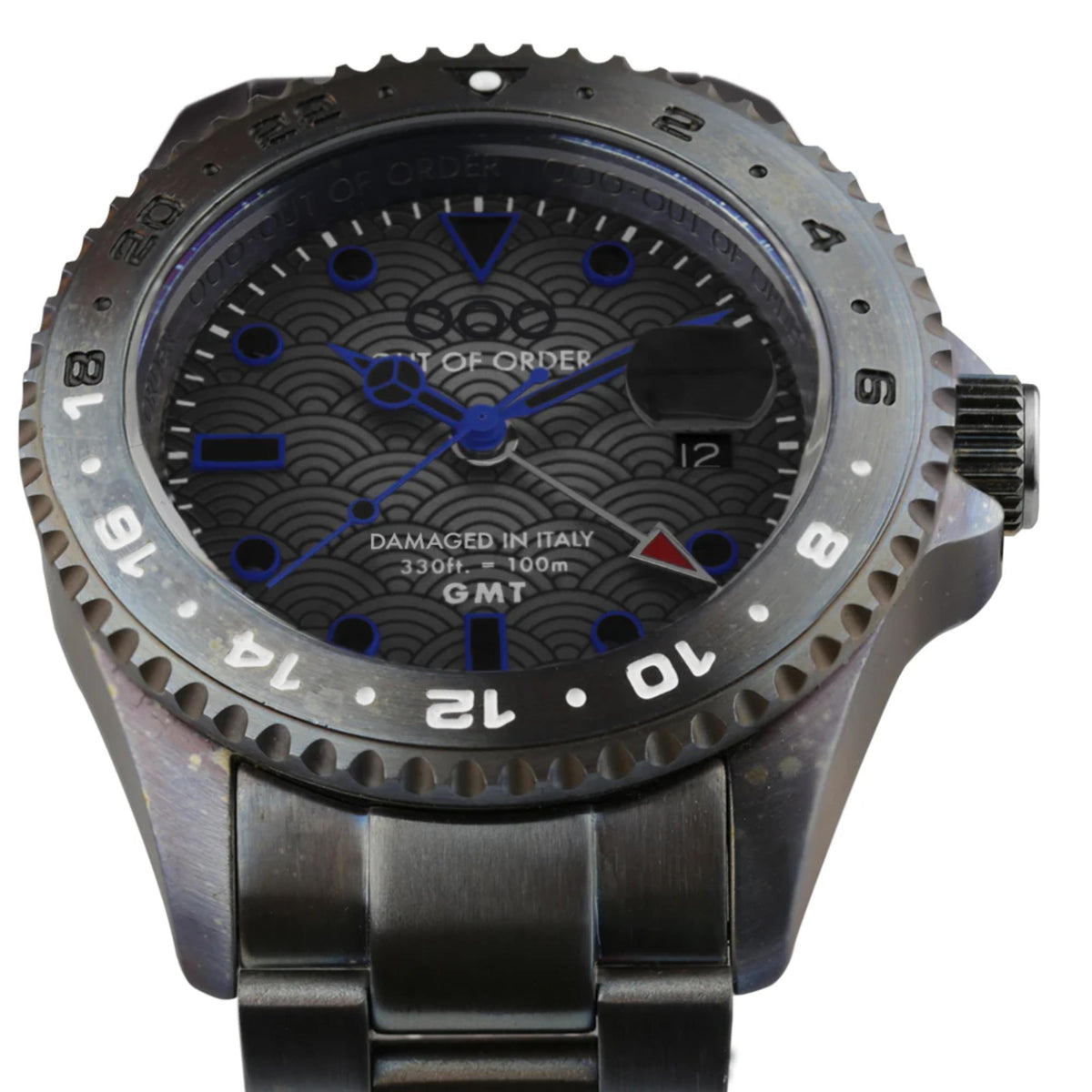 Men's distressed dark grey wristwatch close-up with blue dial, bold numerals, and bezel teeth