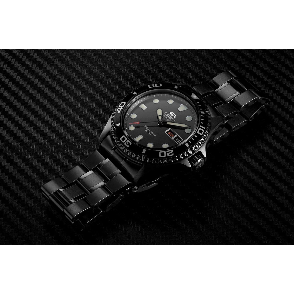 Men's automatic diver watch lying flat, black dial and black steel bracelet