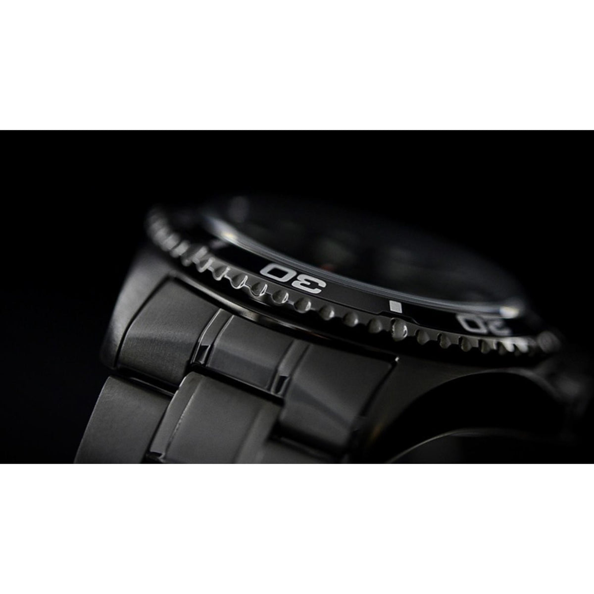 Men's automatic diver watch bezel and crown detail with black steel case