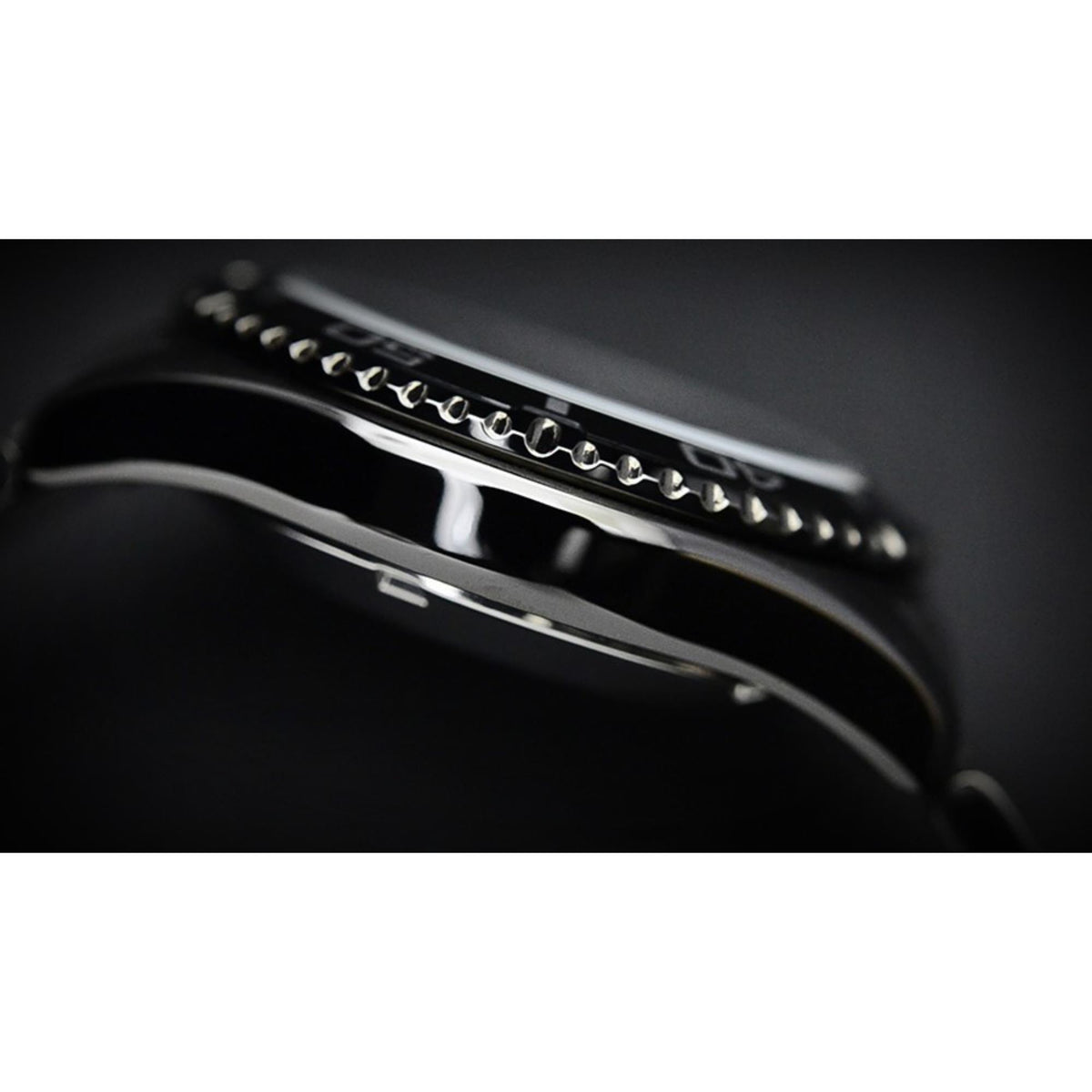 Men's automatic diver watch side profile with black steel bezel and bracelet