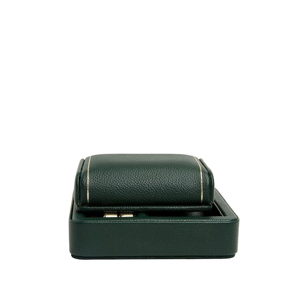 Green leather single watch travel stand with hinged cover and stitched trim.