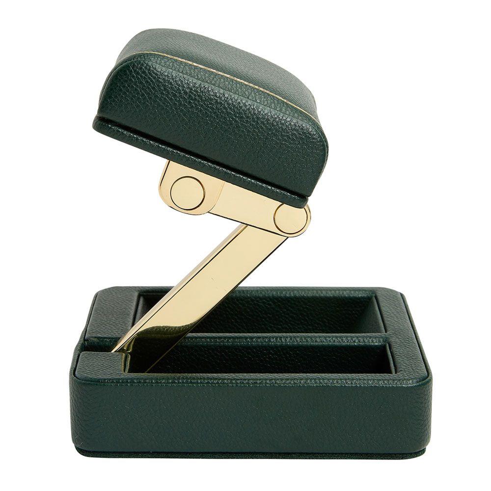 Open green watch stand with brass-tone support arm and padded cradle.