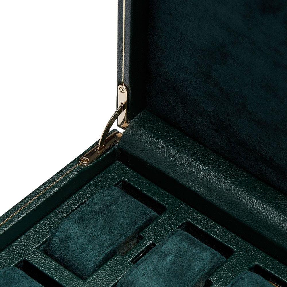 Open watch box hinge and lock detail with dark green padded insert, visible stitching
