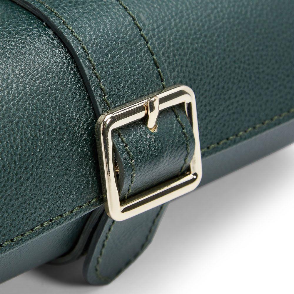 Close-up of green watch roll buckle clasp on textured leather strap