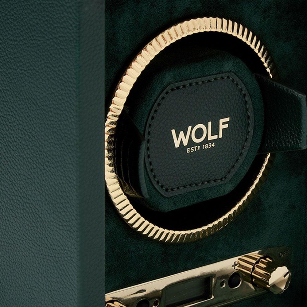 Close-up of dark green winder pad with WOLF label and gold coil ring