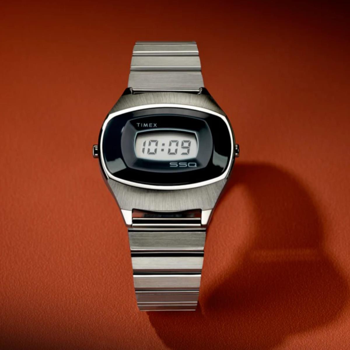 Digital steel watch with blue LCD display and brushed metal bracelet