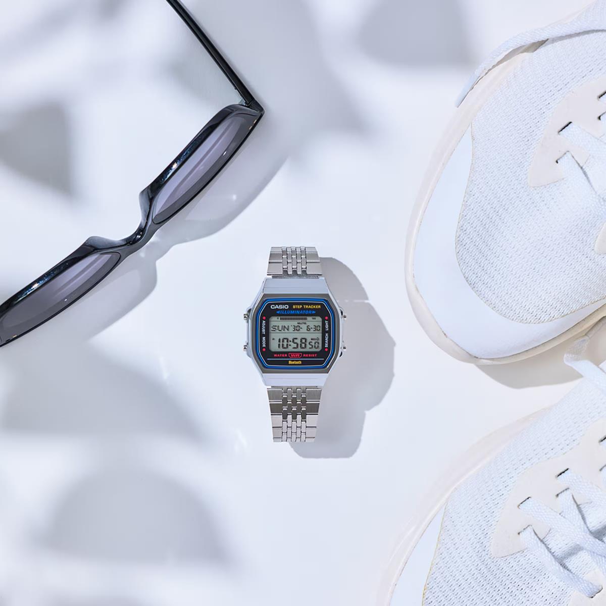 Casio digital watch with silver metal bracelet and small illuminated LCD screen
