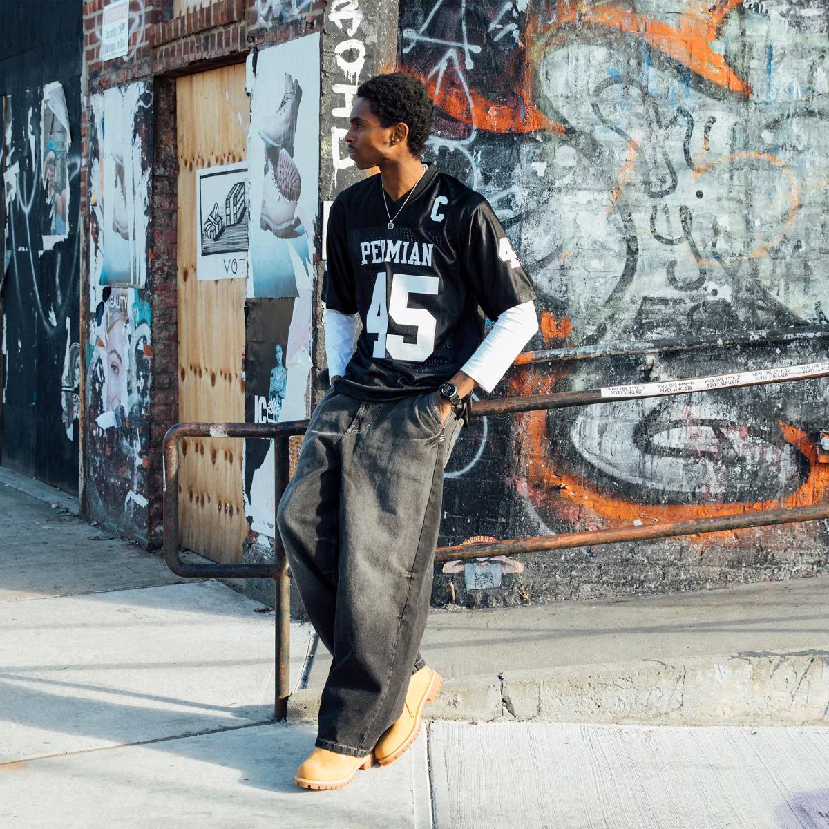 Casio G-Shock DW-6900RL-1ER digital watch paired with urban streetwear against a graffiti wall background