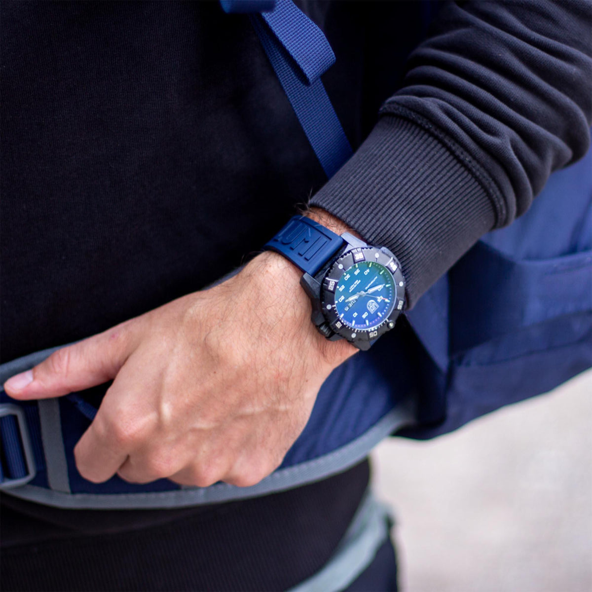 Luminox Master Carbon SEAL XS.3863 blue dial automatic timepiece lifestyle view showing the watch worn on the wrist with outdoor gear