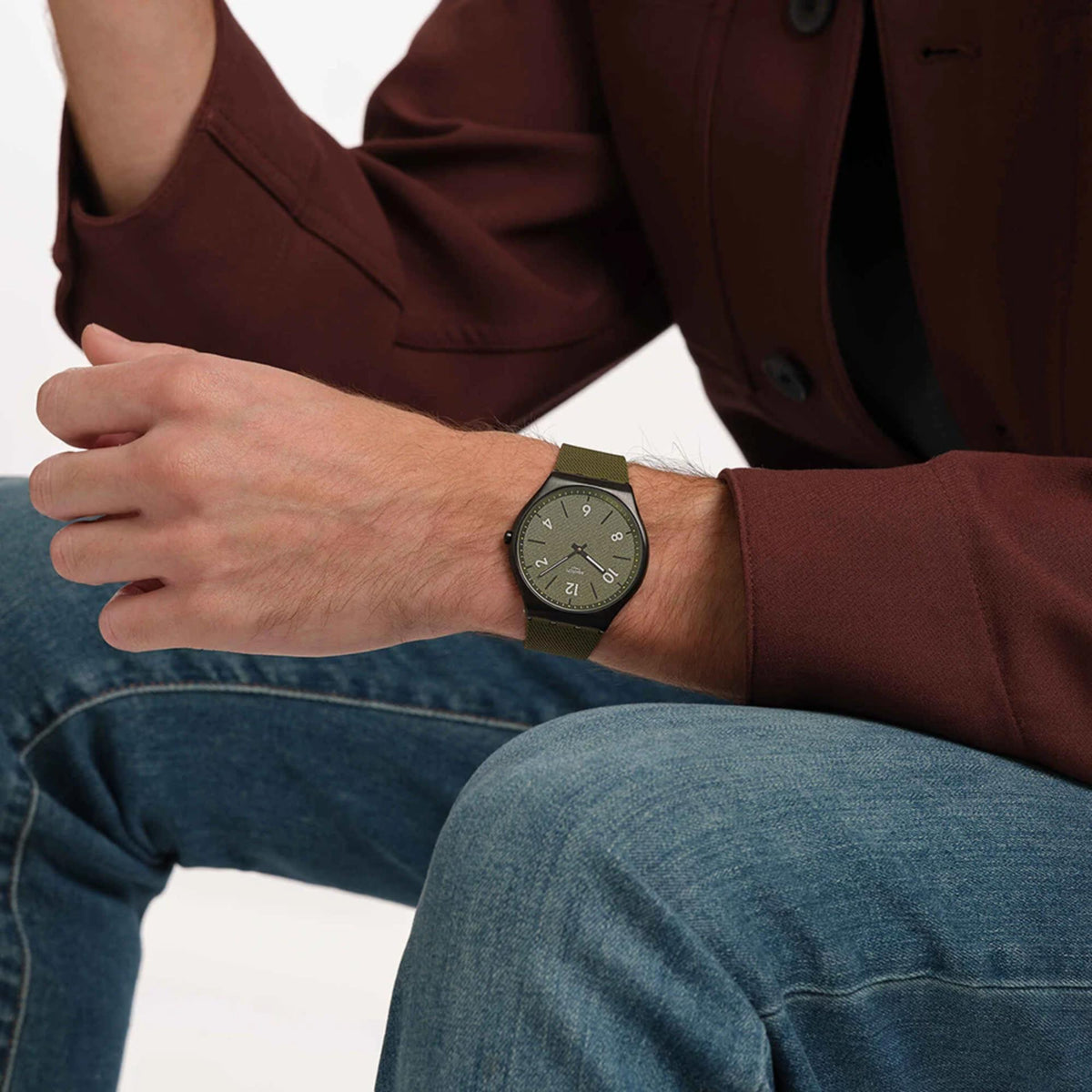 Pine green dial rubber strap watch with black case, worn on wrist