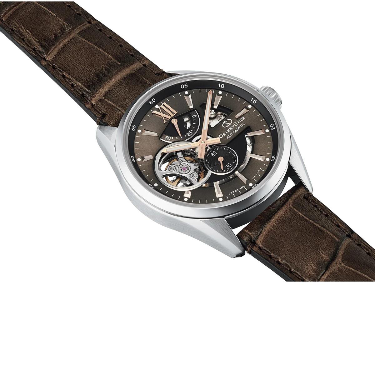 Skeleton-style men's watch with brown dial, silver case, leather strap
