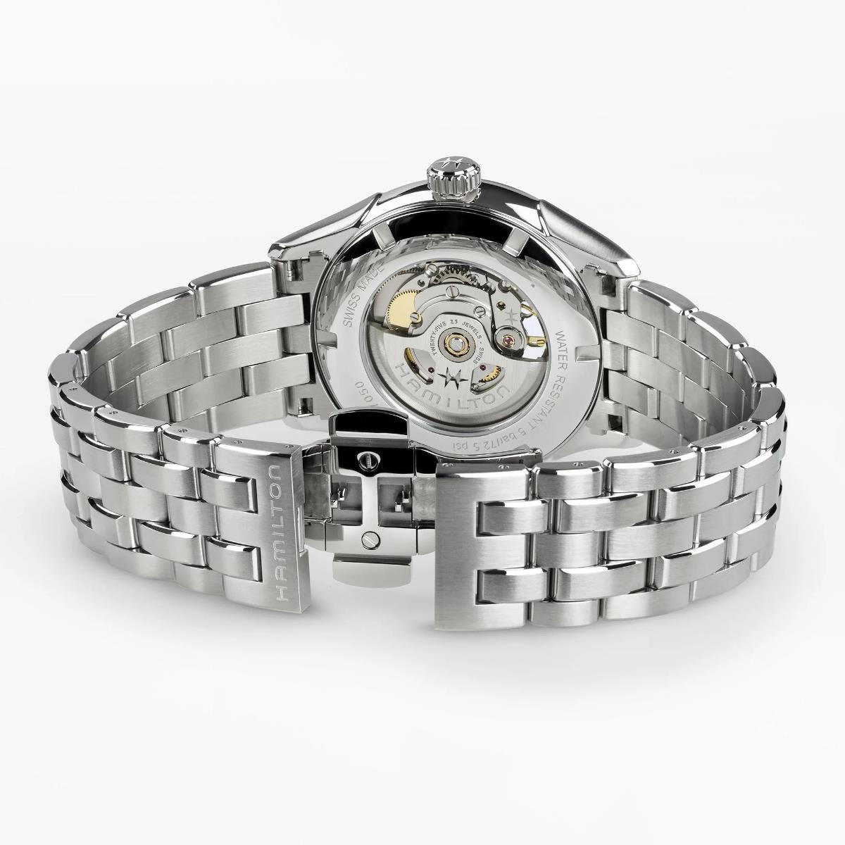 Steel automatic watch caseback with bracelet links and visible internal mechanism