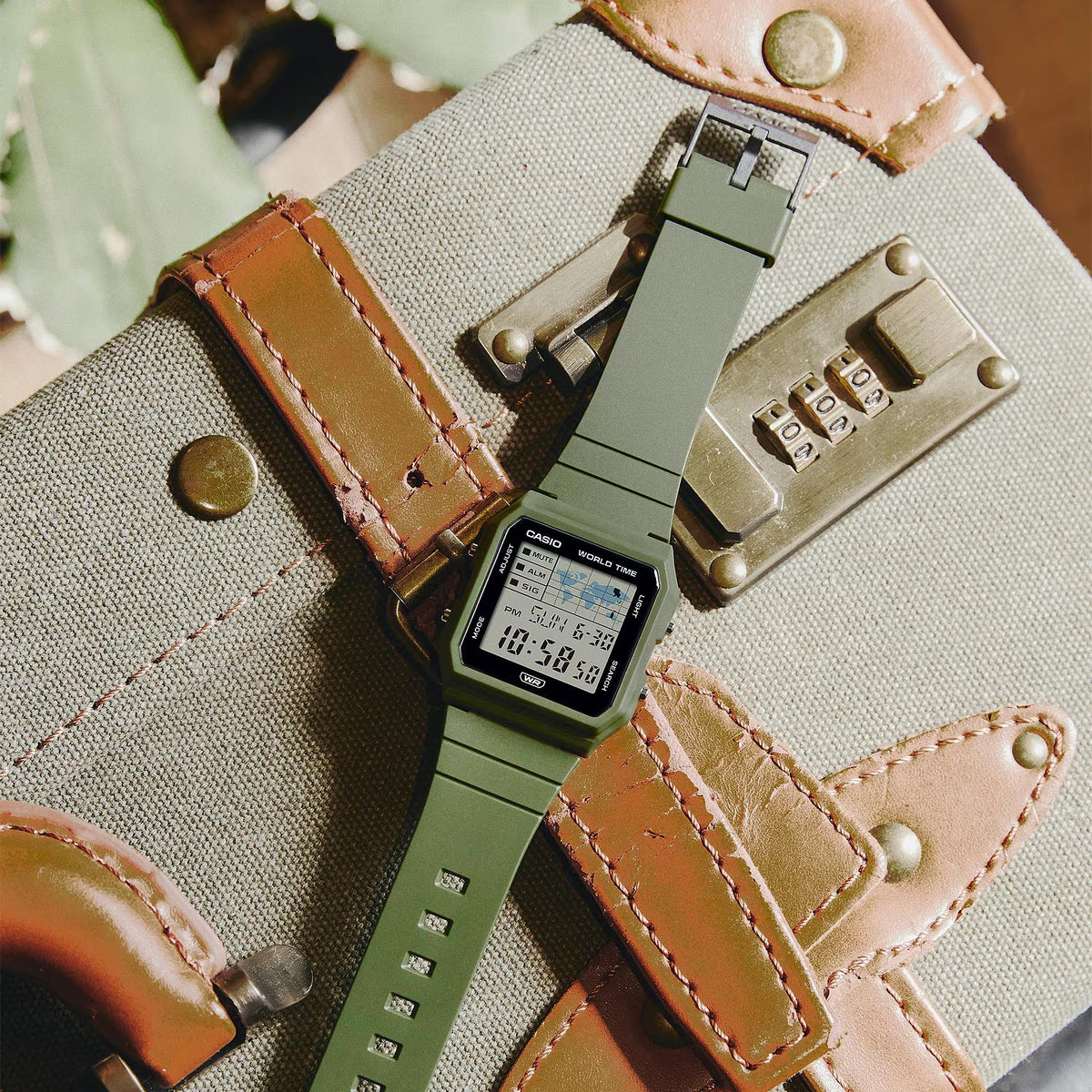 Casio digital resin watch on canvas with green resin strap, metal buckle, and LCD time display