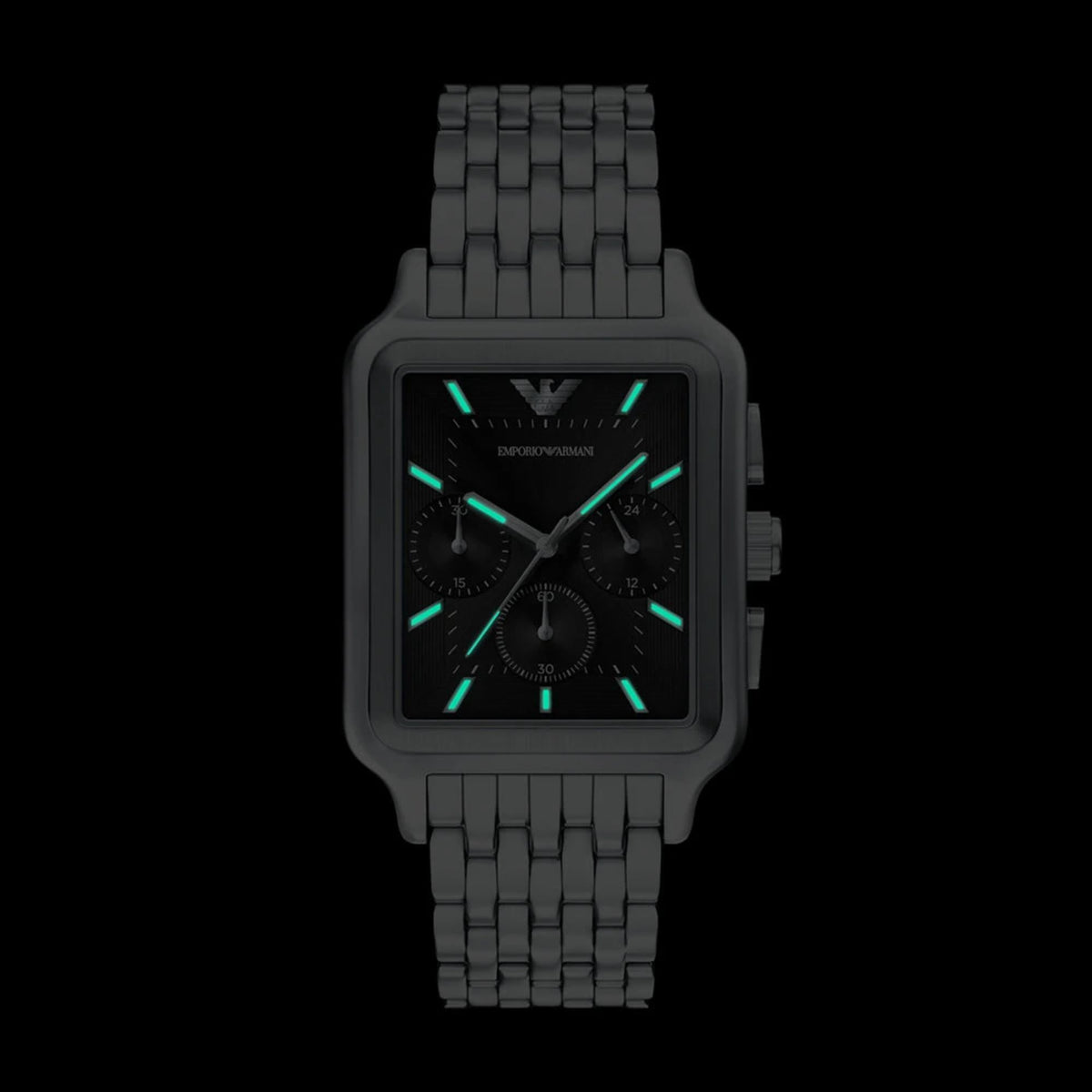 Front view of the Emporio Armani AR11751 watch in the dark showing its green luminescent hands and indices