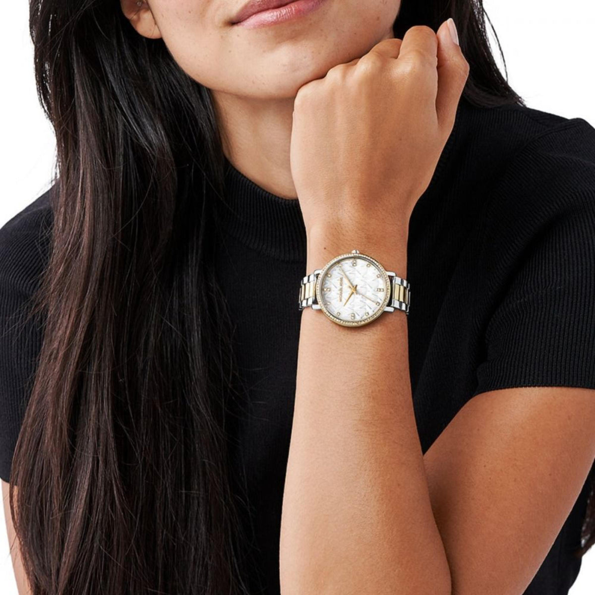 Two-tone Michael Kors Pyper watch on wrist with white dial and steel/gold bracelet
