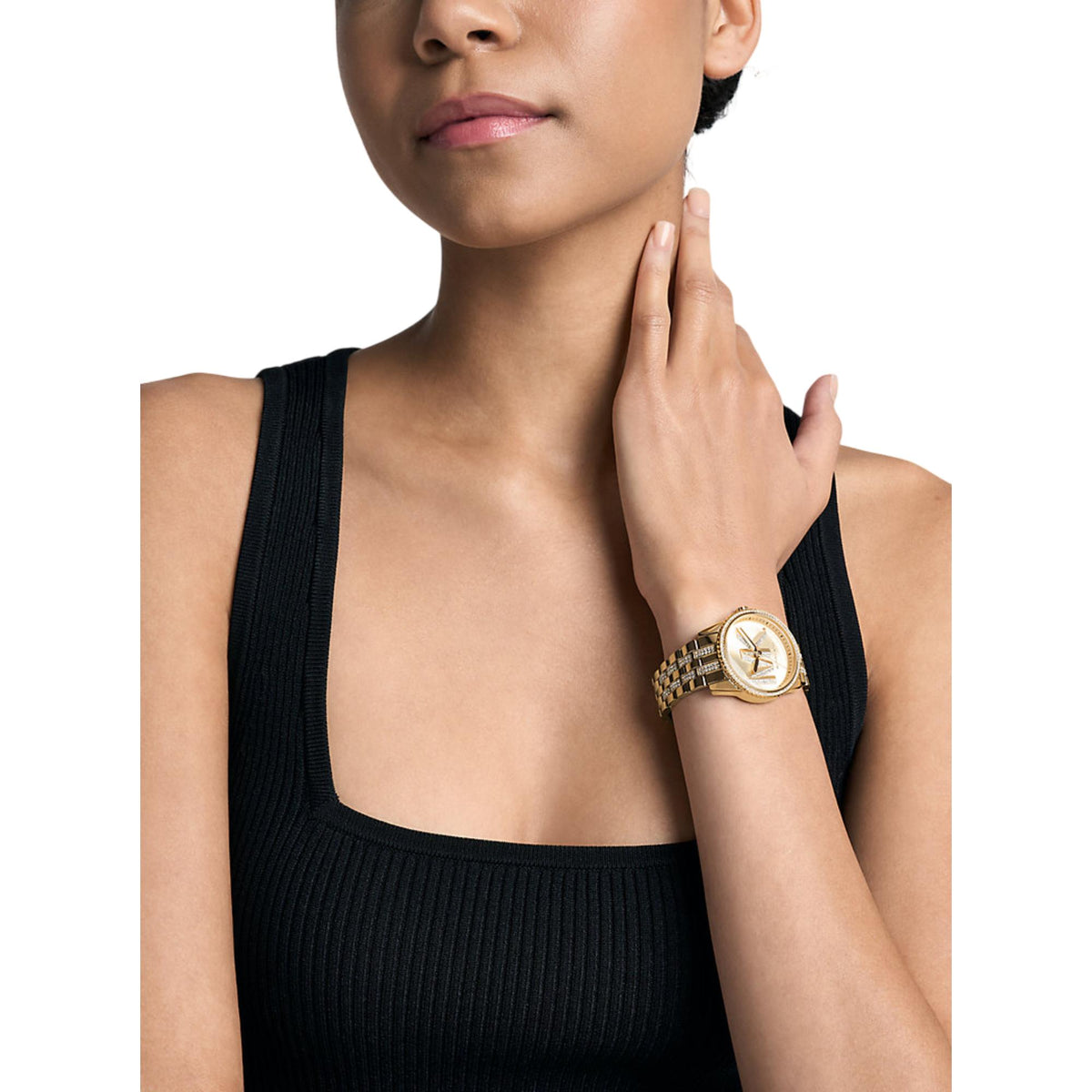 Gold-tone ladies quartz watch on wrist with rhinestone bracelet and gold dial