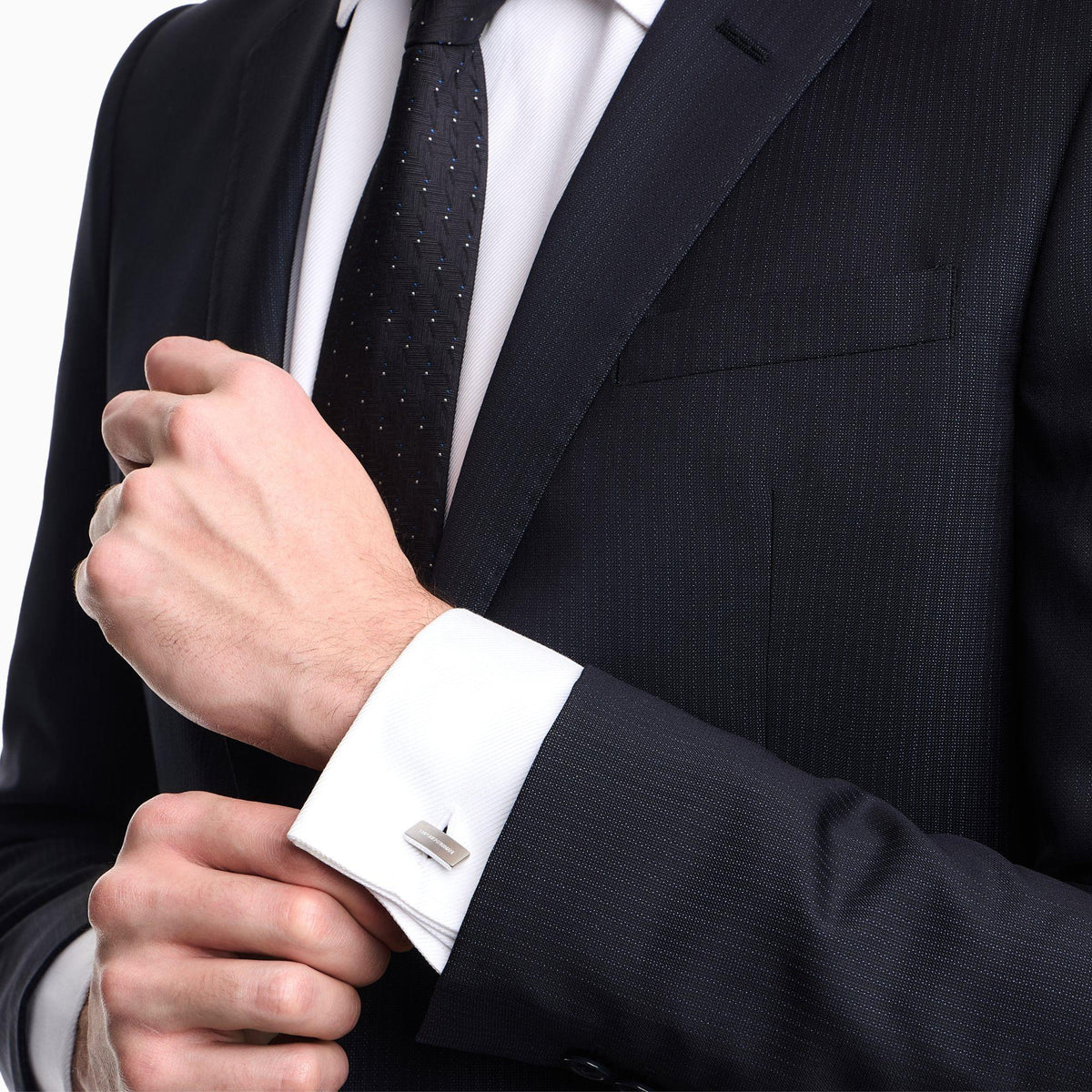 Silver stainless steel cuff links on a dress shirt cuff, rectangular bar design