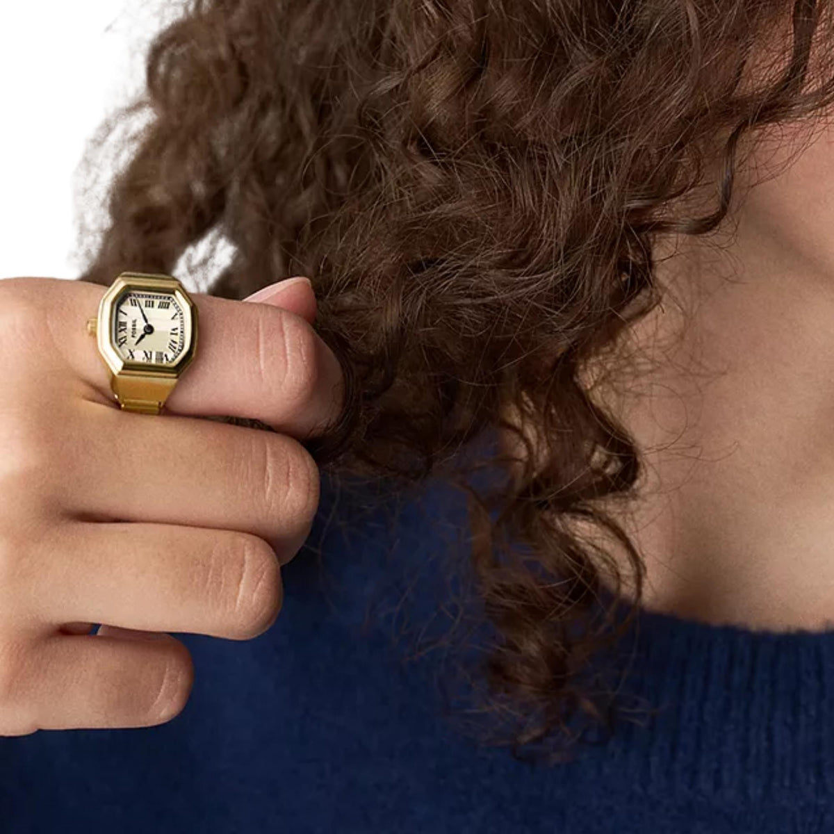 On-finger view of the Fossil Harlow ES5446 cream dial quartz ring watch showcasing its gold-tone band and compact case design