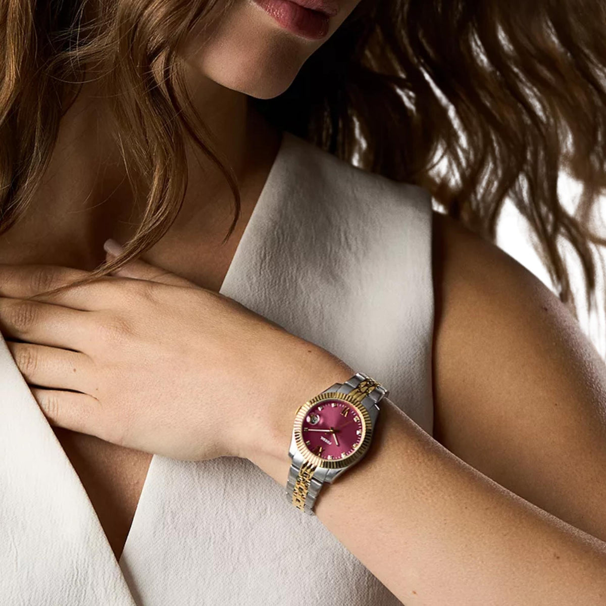 Ladies quartz wristwatch with two-tone bracelet and pink dial worn on wrist