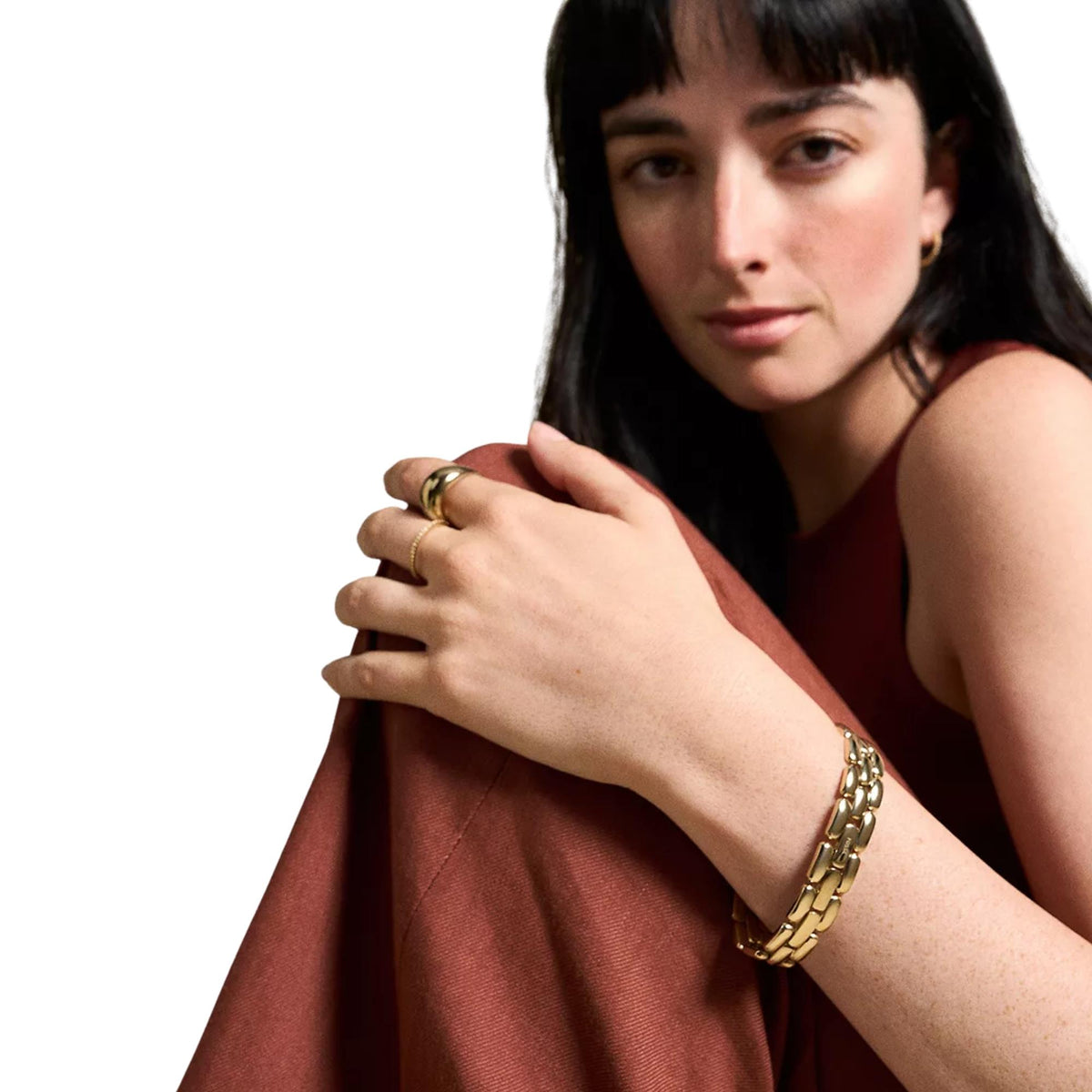 Gold-tone chain bracelet on wrist with rectangular links