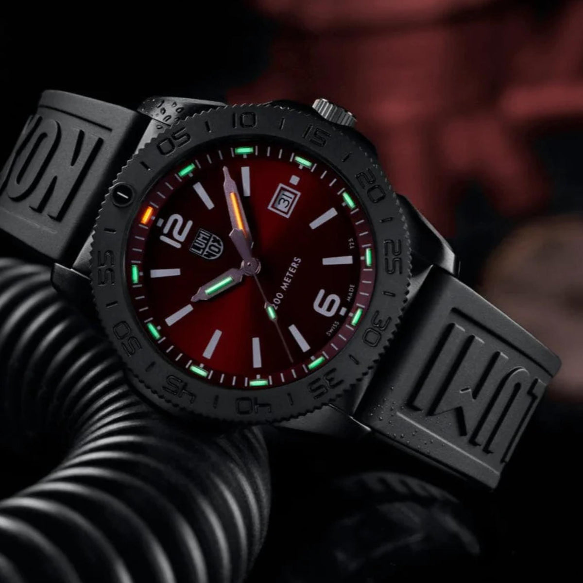 Pacific Diver 44mm quartz diver watch in glove, red dial with green glow markers